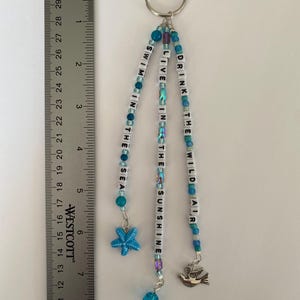 May include: A set of three ceramic nesting bowls in shades of blue, green, and white. The bowls feature a speckled glaze and a simple, modern design. The largest bowl measures approximately 8 inches in diameter.