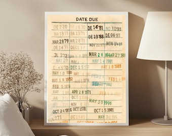 May include: A framed vintage library card with the words "DATE DUE" at the top. The card has multiple handwritten entries with dates and numbers, giving it a nostalgic feel. The frame is white.
