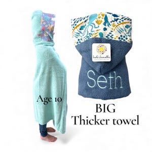 May include: A hooded towel in light mint green and dark blue featuring an embroidered name Seth and a colorful ocean-themed pattern with sea creatures on the hood. The text Age 10 and BIG Thicker towel are visible alongside the product.