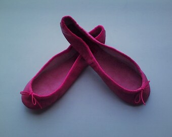 May include: A pair of pink ballet flats with a bow on the toe.