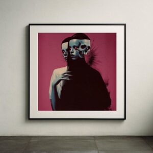 May include: A framed art print featuring a surreal image of two figures. One figure is in a white shirt, the other in black, with a skull-like face. The background is a deep pink.
