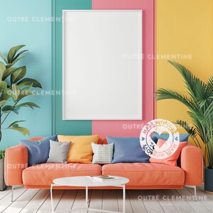 May include: A coral orange sofa with blue, yellow, and gray throw pillows. The sofa is in front of a wall with a white frame and a colorful circle sticker that says "Made with Love".