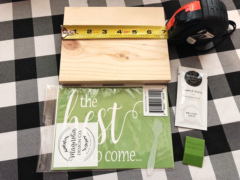 May include: A wooden sign with the text "the best to come..." on a green background. The sign is packaged with a stencil, a spatula, and a small packet of white paint. The sign is 7 inches by 10 inches.