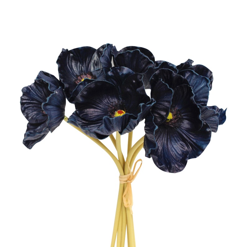 May include: A bouquet of dark blue artificial poppy flowers with yellow centers. The stems are bundled together with twine.