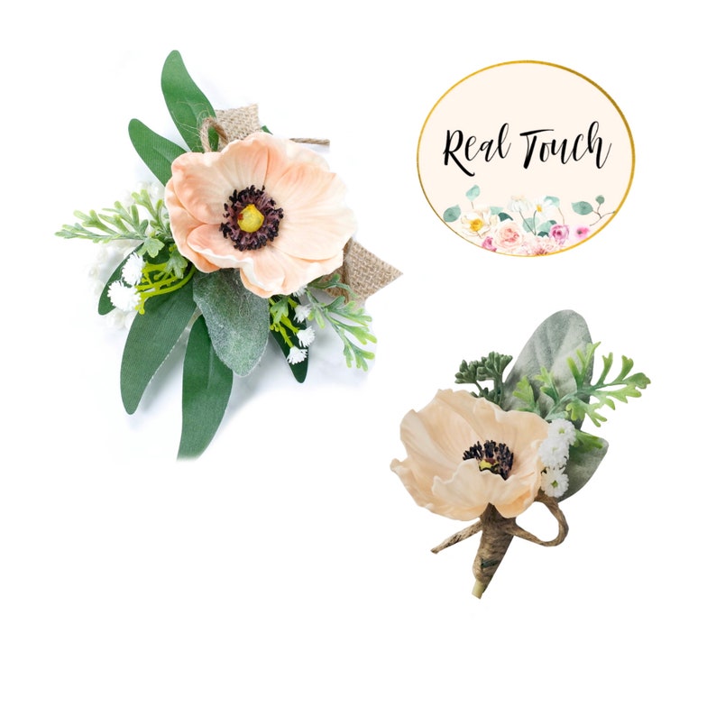 May include: Two peach-colored artificial flower boutonnieres with greenery and burlap accents. The boutonnieres are tied with twine. The image includes the text "Real Touch".