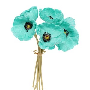May include: A bouquet of six teal blue artificial poppy flowers with black centers and yellow stamens. The stems are brown and tied together with twine.