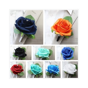 May include: Assortment of ten single rose boutonnieres in various colors, including black, white, red, orange, blue, and turquoise. Each boutonniere features a single rose with a rhinestone accent.
