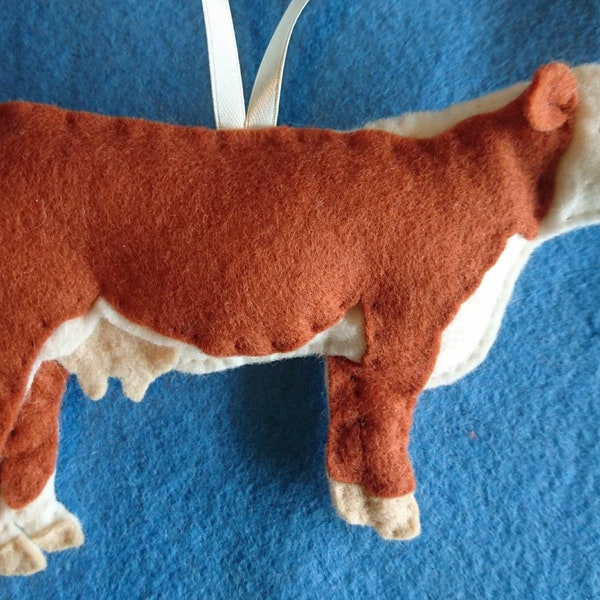 Hereford Cow felt hanging ornament with hand embroidered detail. Filled with wool from my certified organic sheep flock
