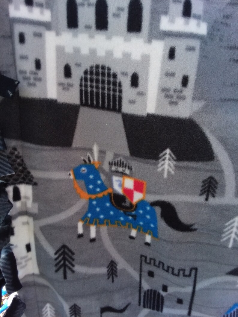 35W x 42L The design is fiery dragons with brave knights..What a fun throw!!! DragonsKnights Toddler Throw in 100/% polyester fleece