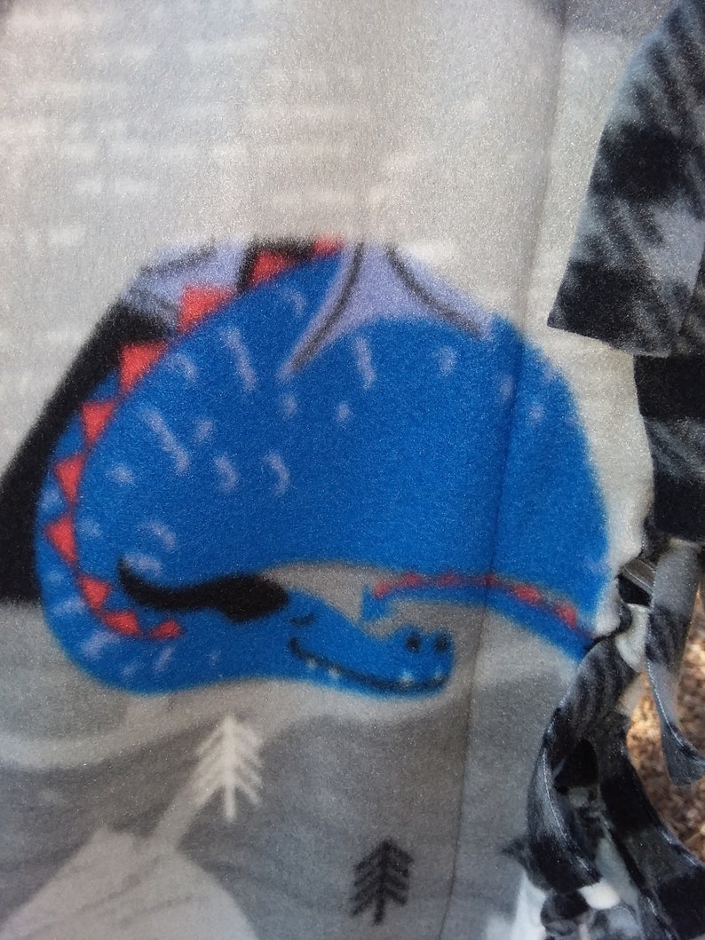 35W x 42L The design is fiery dragons with brave knights..What a fun throw!!! DragonsKnights Toddler Throw in 100/% polyester fleece