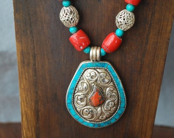 Tibetan turquoise and coral pendant necklace and Buddhist symbols