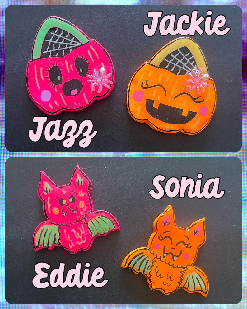 May include: Four Halloween-themed resin pins with cute faces. Two are orange pumpkin-shaped trick-or-treat bags with spiderwebs and glitter. Two are bats with pink and orange bodies and green wings.