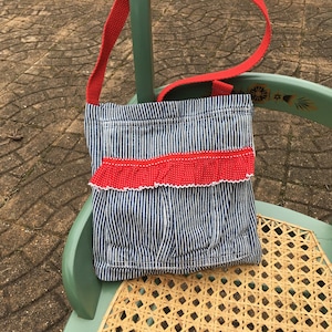 Denim bag, striped denim and red.  Cute, practical. Large pocket.