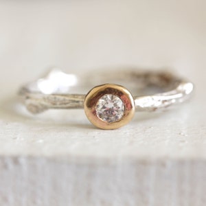 Twig diamond engagement ring in sterling silver and 14k gold. Gold bezel sterling silver band, round diamond.