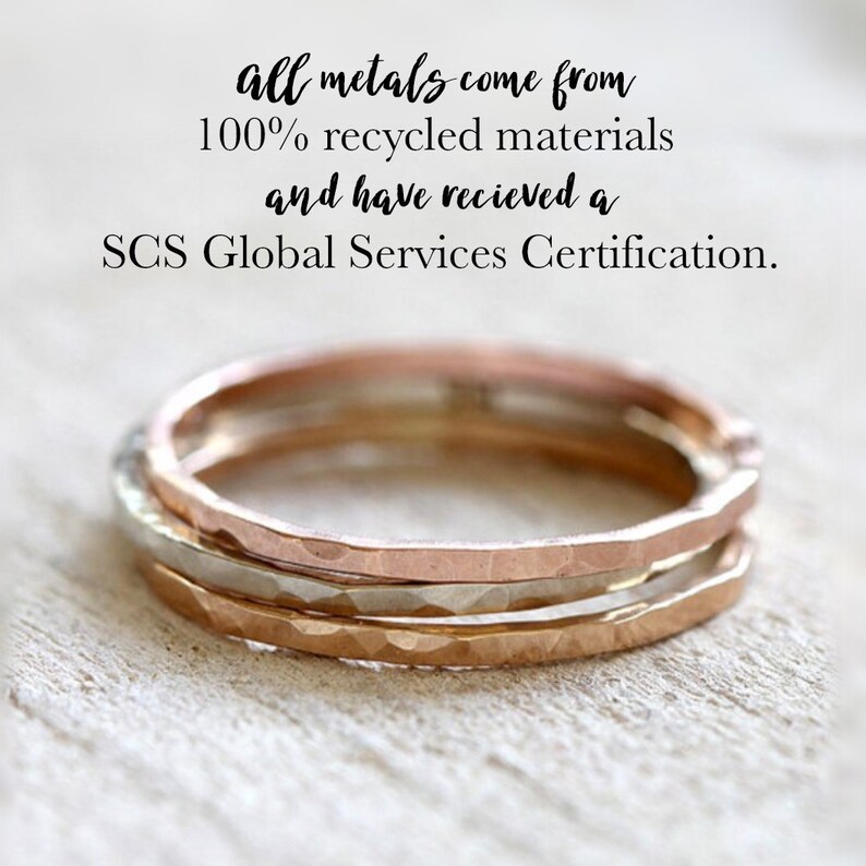 May include: Three thin gold rings stacked on top of each other. The rings are made from 100% recycled materials and have received a SCS Global Services Certification.  "all metals come from 100% recycled materials and have received a SCS Global Services Certification."