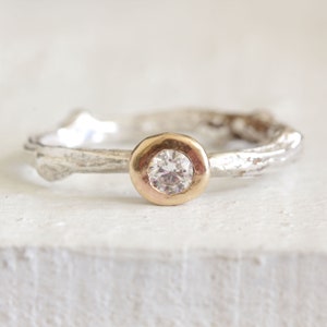 Twig diamond engagement ring in sterling silver and 14k gold. Gold bezel sterling silver band, round diamond.