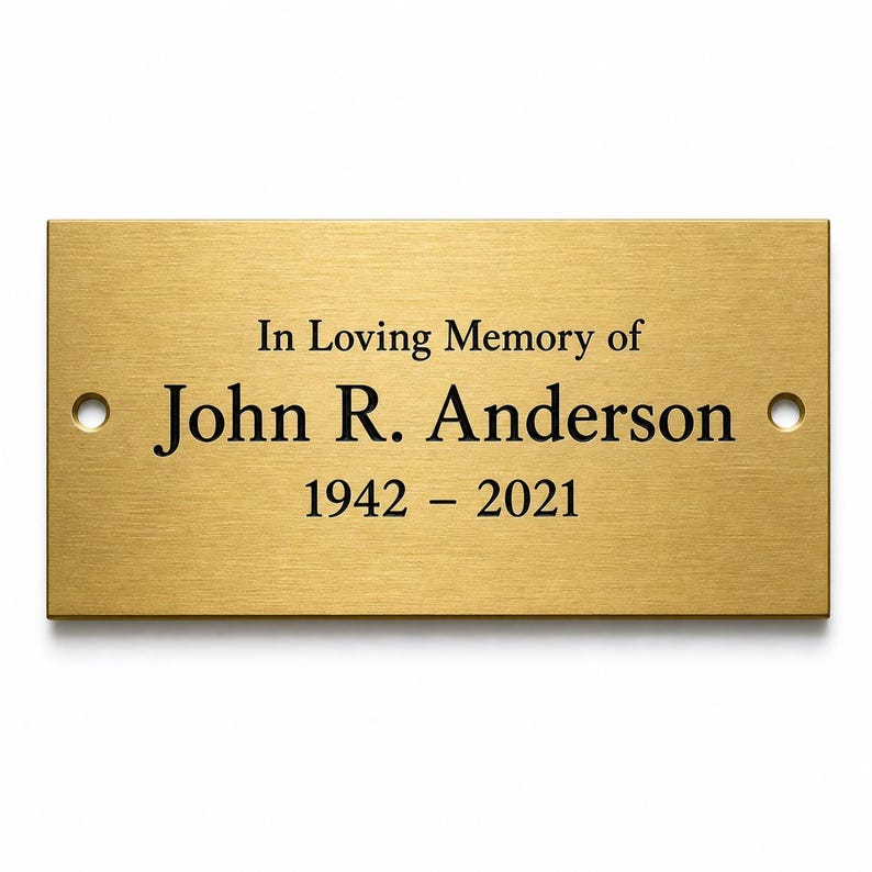Pu&ograve; includere: Una targa commemorativa rettangolare in metallo dorato spazzolato con testo inciso in nero che recita In Loving Memory of John R. Anderson 1942 - 2021. La targa presenta un foro di montaggio circolare sui lati sinistro e destro per il fissaggio.