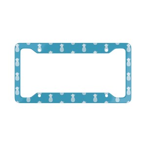 May include: A blue license plate frame with a white pineapple pattern.