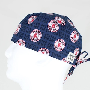 May include: A blue scrub hat with a white and red Boston Red Sox logo pattern. The hat has a tie on the back.