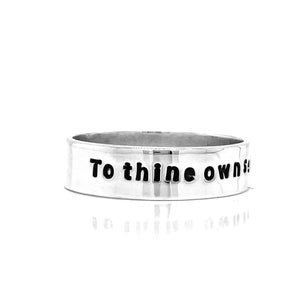 May include: A silver ring with the inscription "To thine own self be true" engraved on the band.