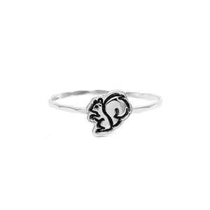 May include: A silver ring featuring a small, detailed squirrel design. The ring is thin and has a hammered texture.