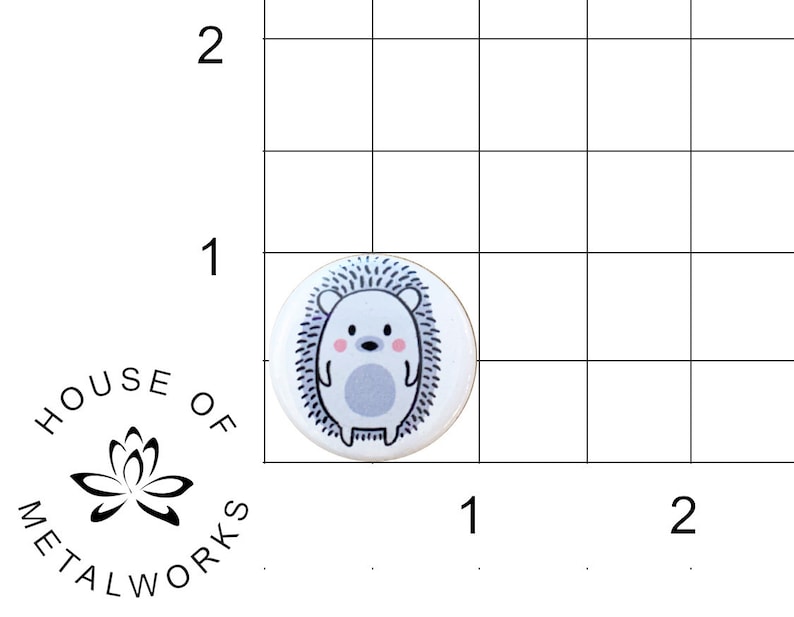 May include: A white button with a cute cartoon hedgehog with pink cheeks and a gray body. The hedgehog is surrounded by a black outline and a white background.