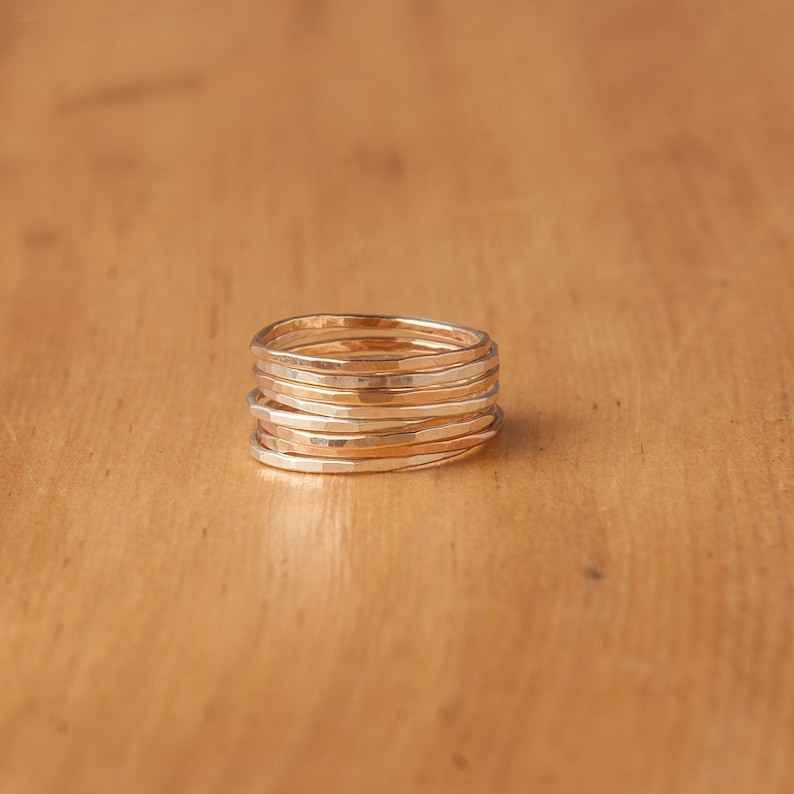 An image displaying a stack of these hammered rings, illustrating how beautifully they complement each other when worn together.
