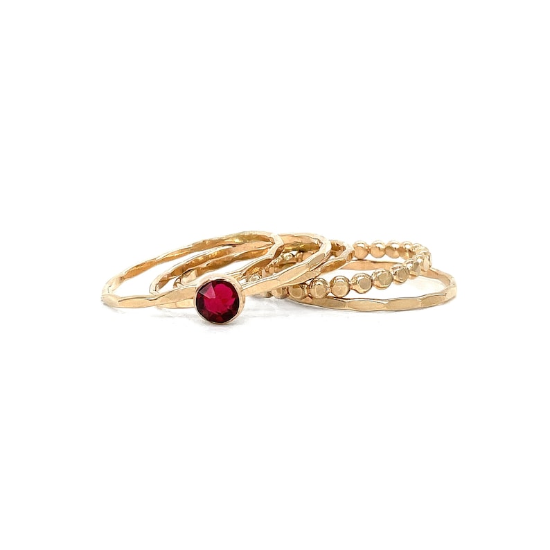 Add a touch of summer's vibrant hues to your style with our Ruby Crystal Solitaire Stacking Ring Set, a perfect tribute to July birthdays.