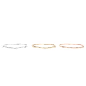 May include: Three simple, thin, minimalist rings in silver, gold, and rose gold.