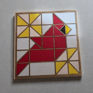 May include: A square wooden puzzle featuring a geometric design of a cardinal bird. The bird is composed of red, yellow, white, and black painted wooden blocks, set within a natural wood frame. The puzzle is a creative and educational toy.