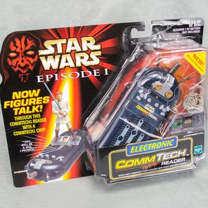 May include: Star Wars Episode I Electronic CommTech Reader toy in original packaging. The packaging features Darth Maul and a figure of Obi-Wan Kenobi. The reader is dark blue with silver accents and includes CommTech chips.