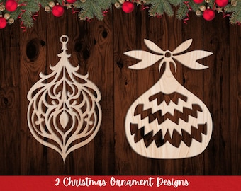 May include: Two laser cut wooden Christmas ornament designs. One ornament is a traditional Christmas tree shape with intricate details. The other ornament is a round shape with a zig-zag pattern.