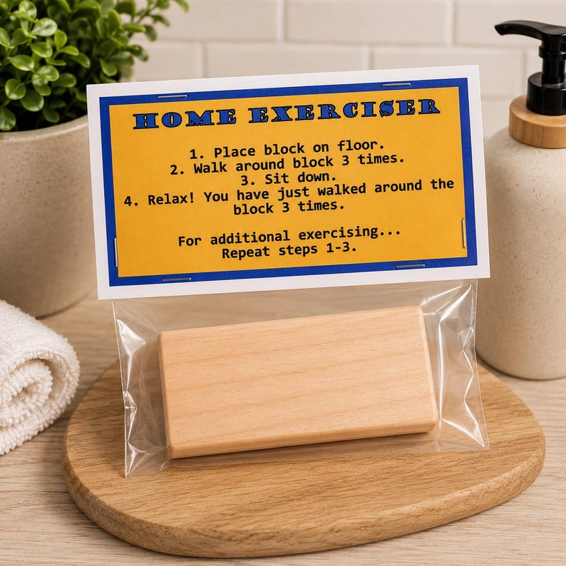 May include: A rectangular light-colored wooden block packaged in a clear plastic bag with a yellow header card. The card features blue text that reads HOME EXERCISER and provides four numbered instructions for a humorous exercise routine.