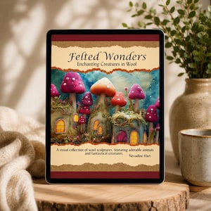 Può includere: Un tablet digitale che mostra la copertina di un libro intitolata Felted Wonders: Enchanting Creatures in Wool di Nevadine Hart. La copertina presenta case in feltro a forma di fungo con finestre gialle luminose.