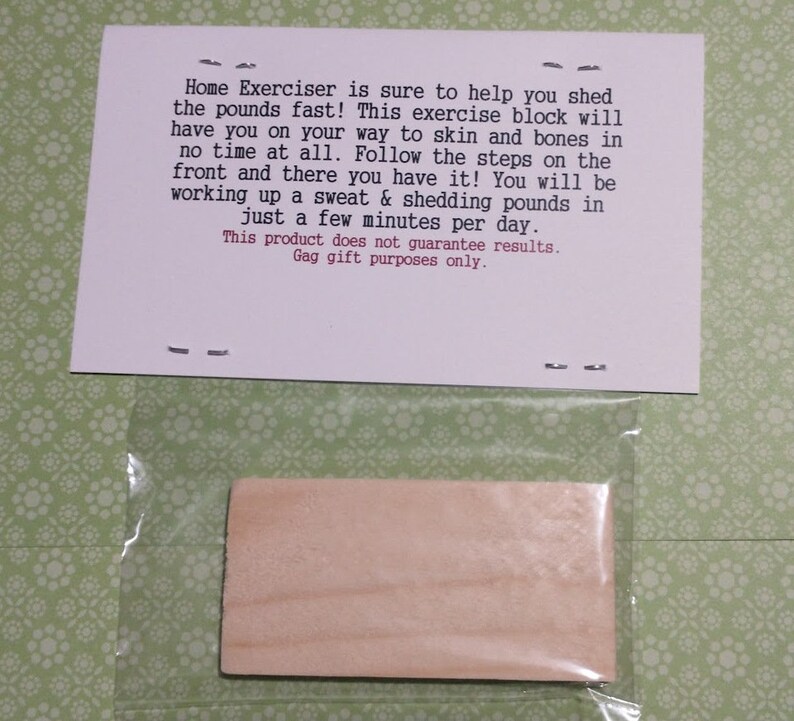 May include: A rectangular wooden block inside a clear plastic bag, accompanied by a white card with the text: Home Exerciser is sure to help you shed the pounds fast! This exercise block will have you on your way to skin and bones in no time at all.