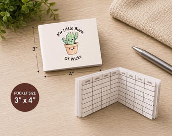 May include: A white pocket-sized notebook measuring 3 inches by 4 inches. The cover features a cartoon cactus in a pot with the text My Little Book Of Pricks. The interior pages contain a printed grid with columns labeled Date and Level.
