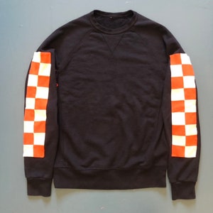 Altered Black sweatshirt with added checkered orange and white sleeves