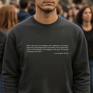 May include: Dark gray sweatshirt with the text "This is what the Lord Almighty said: 'Administer true justice; show mercy and compassion to one another..." and the reference "ZECHARIAH 7:9-10".