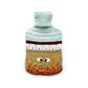 Knitted Lambswool hot water bottle cover featuring a countryside design.