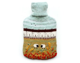 Knitted Lambswool hot water bottle cover featuring a countryside design.