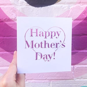 May include: A white card with a pink heart-shaped design that says "Happy Mother's Day!"