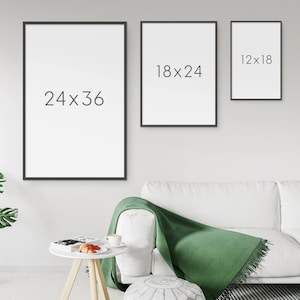 May include: Three black picture frames with white backgrounds hanging on a white wall. The frames are different sizes. The largest frame is 24x36 inches, the middle frame is 18x24 inches, and the smallest frame is 12x18 inches.