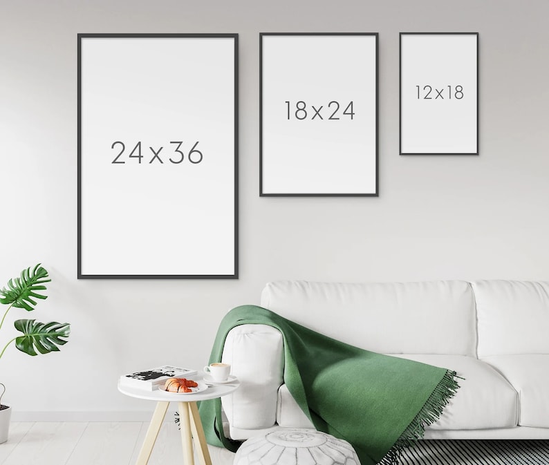 May include: Three black picture frames with white backgrounds hanging on a white wall. The frames are different sizes. The largest frame is 24x36 inches, the middle frame is 18x24 inches, and the smallest frame is 12x18 inches.