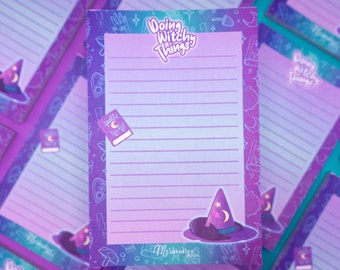 May include: Purple and blue lined notepad with a witch hat and the text "Doing Witchy Things" on the front. The notepad has a whimsical design with stars, moons, and other witchy elements.
