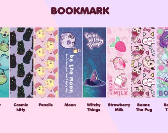 May include: A set of ten colourful bookmarks featuring various illustrations and designs. The bookmarks include a frog, a cat, pencils, a moon, a witch, a strawberry, a dog, and a boba tea. The bookmarks are all rectangular and have a white background.