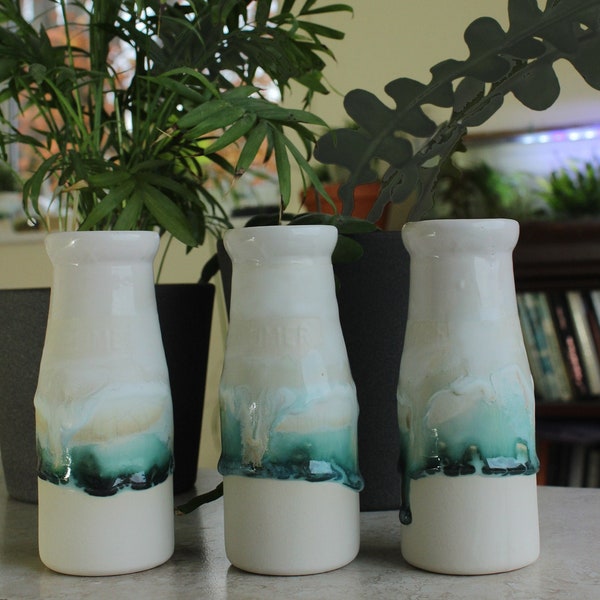 1 ceramic bottle. Ceramic vase, milk bottle bud vase with landscape painting in glazes. Ceramic white vase. Contemporary interior design.