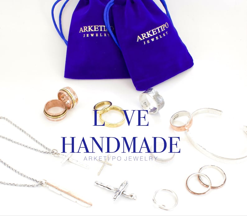 May include: An assortment of handmade jewelry, including rings, necklaces, and a bracelet, is displayed on a white surface. The word "LOVE" and "HANDMADE" are featured in the image. The jewelry includes silver, gold, and rose gold tones, with some pieces featuring intricate designs.