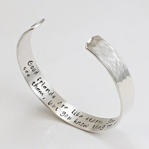 May include: Silver hammered bangle bracelet with an inscription that reads "Good friends are like stars. You don't always see them, but you know they're always there."