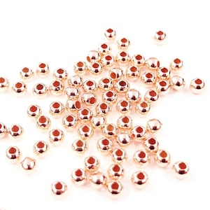 May include: A scattering of rose gold beads, perfect for jewelry making or crafting projects.