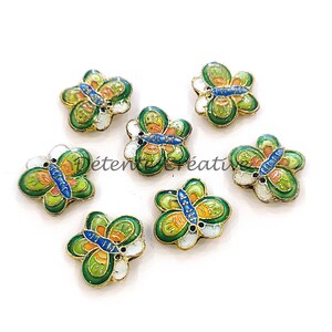 May include: Six green, white, blue and orange enamel butterfly charms with gold accents.